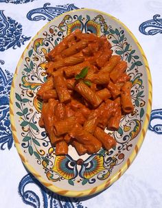 some food is on a colorful plate on a blue and white tablecloth with paisley designs