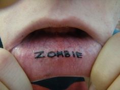 someone has written the word zombie on their tongue and it's in front of them