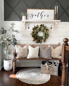 a living room with a couch, coffee table and wreath on the wall