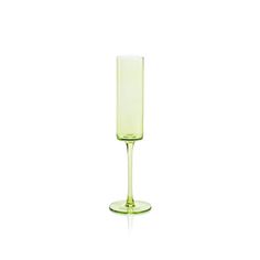 a green wine glass sitting on top of a table