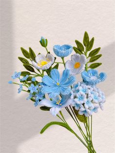 a vase filled with blue and white flowers