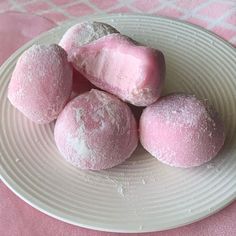 some pink and white desserts on a plate