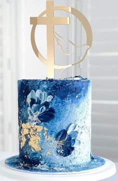 a blue and gold cake with a cross on top