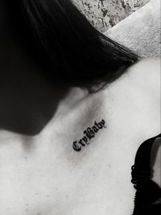 a black and white photo of a woman's chest with the word crayons tattooed on it