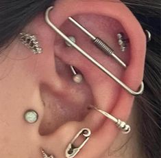 an ear with several piercings attached to it