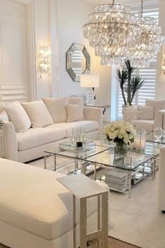 a living room filled with furniture and a chandelier