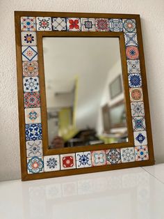 a mirror sitting on top of a white counter