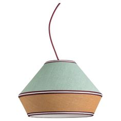 a green and brown lamp shade hanging from a ceiling fixture with a red cord attached to it