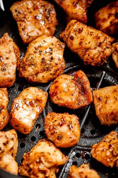 chicken is cooking in a skillet with some seasoning on the top and sides