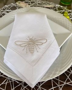 a white plate topped with two napkins on top of a table