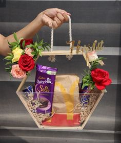 a gift basket with flowers and chocolates in it