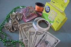 dollar bills, spools of thread and other crafting supplies laid out on a table