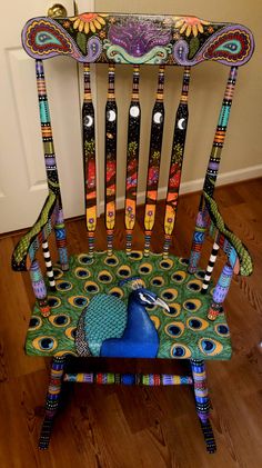 a chair made out of wooden sticks and painted with colorful designs