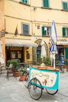 a bike parked in front of a building with an ice cream stand on the back