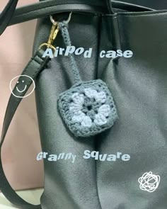 a crocheted bag with an air pod case attached to the front and side