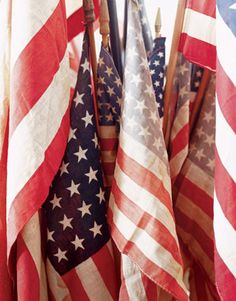 several american flags are hanging in a row