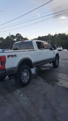 a white pickup truck parked in a parking lot