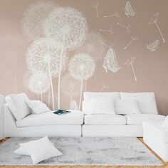 a living room with white furniture and a dandelion mural