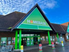 a homebase store with green pillars and signs