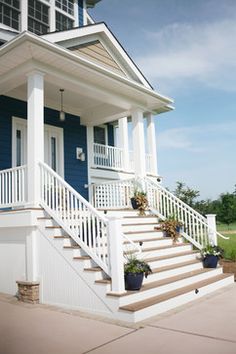 a blue and white house with steps leading up to it