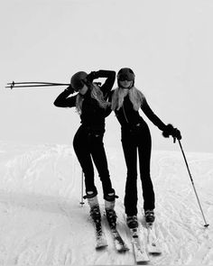 two women on skis posing for the camera