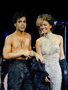 a man and woman standing next to each other on stage