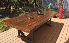 a wooden table sitting on top of a wooden deck