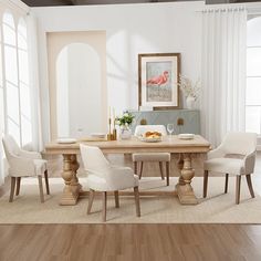 a dining room table with white chairs around it