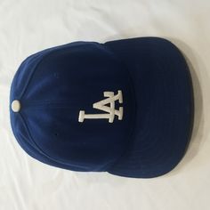 La Dodger Hat. Mens. One Size Fitted Hat 7 1/4 (57.7 Cm). Color Blue And White. Fabric Stretching/ Wear Inside, See Photos. Brand New Era Blue Curved Brim Hat For Baseball Season, Classic Blue Cap Hat, Classic Blue Baseball Cap With Flat Brim, Classic Blue Baseball Cap For Baseball Season, Classic Blue Flat Brim Baseball Cap, Classic Curved Brim Hats For Sports Events, Classic Blue Hats With Curved Brim, Classic Blue Hat With Curved Brim, Vintage Blue Flat Brim Baseball Cap