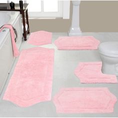 a bathroom with pink rugs and bath mats