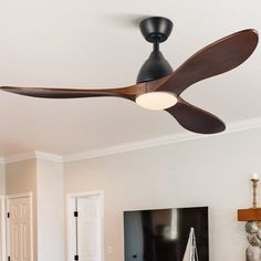 a ceiling fan in a living room with white walls