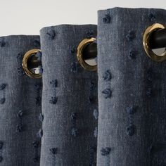 blue curtains with gold rings on them