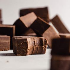 some pieces of chocolate sitting on top of a table next to other pieces of chocolate