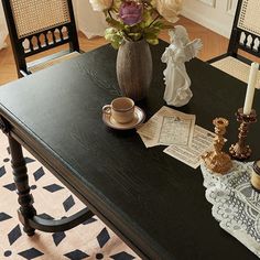 a dining room table with vases and candles on it, along with other decorations