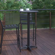 two chairs and a table on a deck