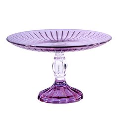 a purple glass cake plate sitting on top of a table