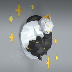 a black and white cat laying on top of a star shaped wall mounted clock with yellow stars around it