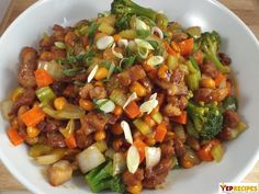 a white bowl filled with vegetables and meat