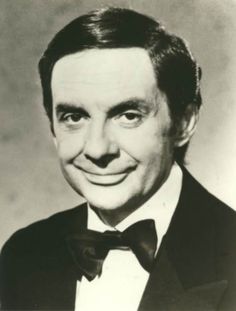 an old photo of a man wearing a suit and bow tie