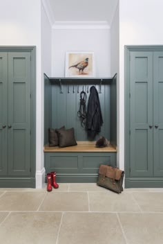 a coat rack with several coats hanging on it and two pairs of boots in the foreground