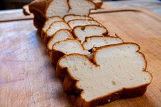 slices of bread sitting on top of a wooden cutting board