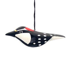 a black and white bird ornament hanging from a string