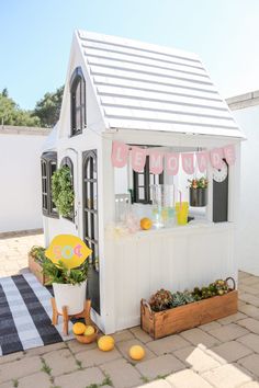 a small white house sitting on top of a patio