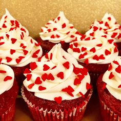 red velvet cupcakes with white frosting and hearts