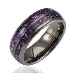 a wedding ring with purple stones inlayed into the center and black plated edges