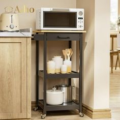 a microwave oven sitting on top of a kitchen cart