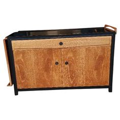 a wooden cabinet with black metal handles