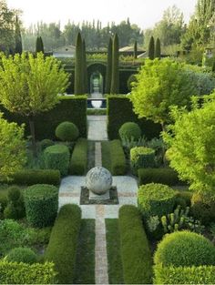 an aerial view of a garden with hedges and trees