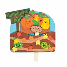 a popsicle shaped like a farm scene with pumpkins and corn