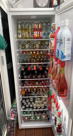 an open refrigerator filled with drinks and condiments